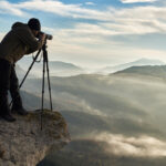 photographer-taking-pictures-on-the-edge-of-a-cliff_INF31371